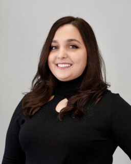 Smiling woman with dark hair in black sweater