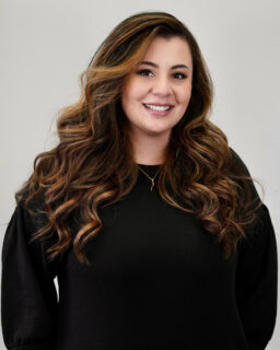 Smiling woman with long wavy brown hair