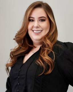 Smiling woman with long wavy brown hair