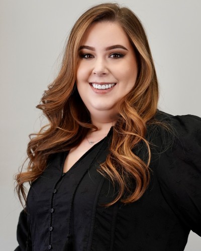 Smiling woman with long wavy brown hair