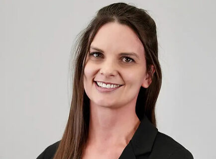 Smiling woman in black blazer portrait