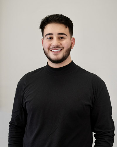 Smiling young man in black turtleneck