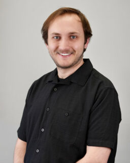 Smiling man in short-sleeve black shirt