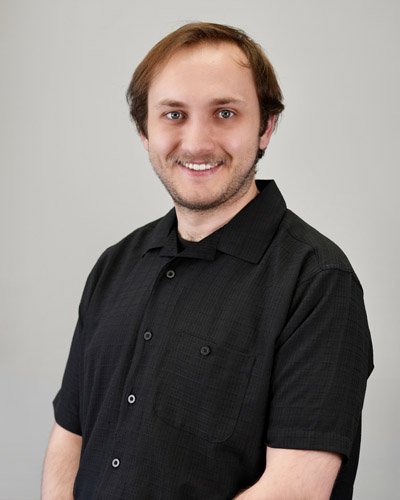 Smiling man in short-sleeve black shirt